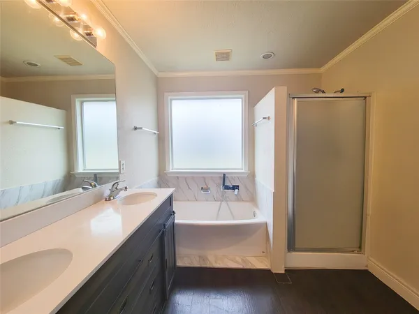 a bathroom with a tub sink and mirror