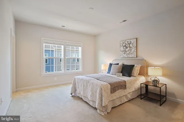 a bed sitting in a bedroom next to a window