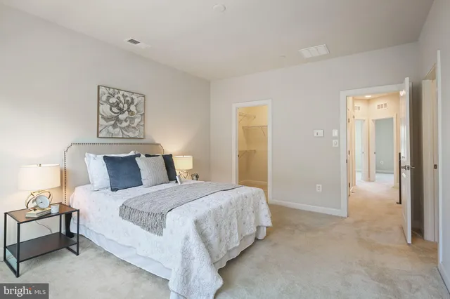 a bedroom with a bed and a lamp