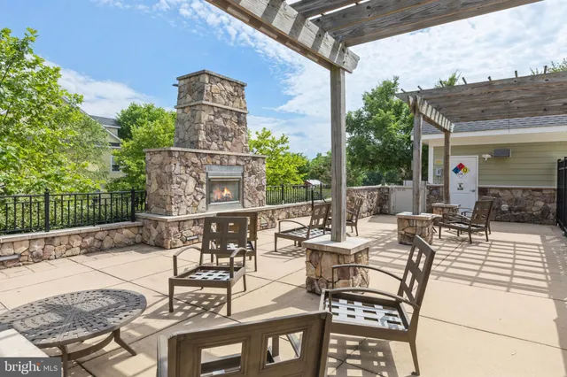 a view of a patio with couches table and chairs and potted plants