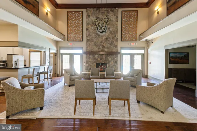 a living room with fireplace furniture and a chandelier
