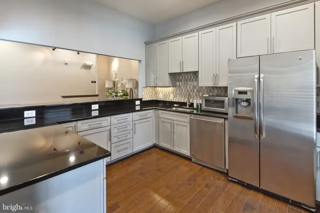 a kitchen with white cabinets and white appliances