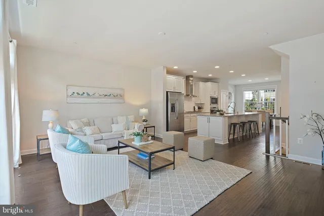 a living room with furniture and kitchen view