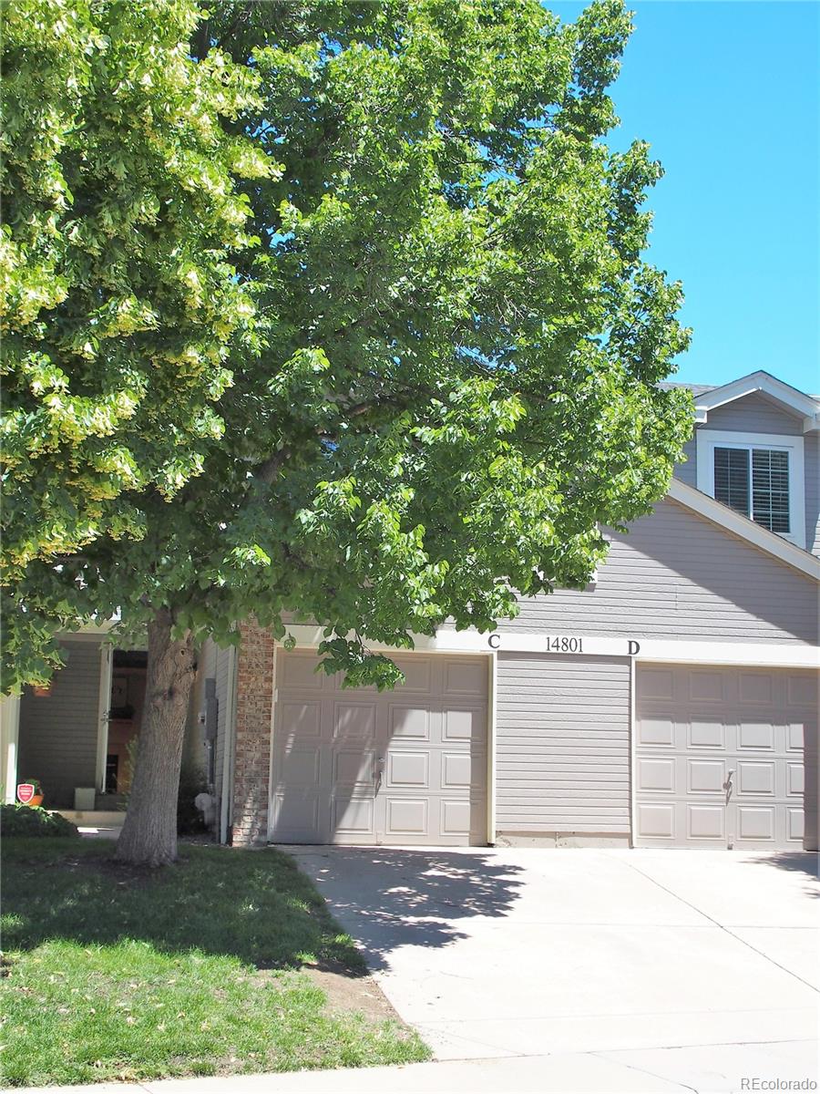 front view of a house with a tree