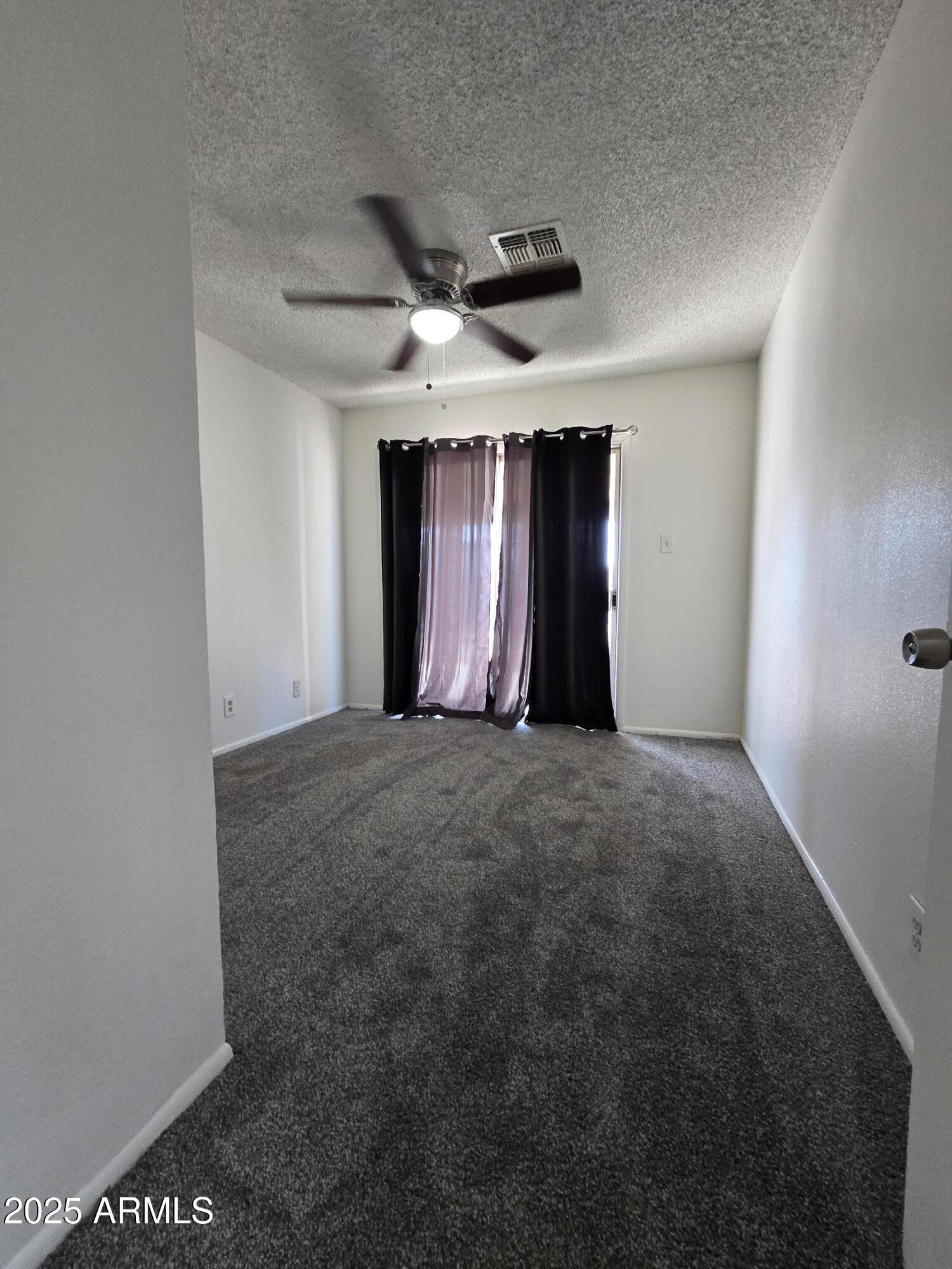 2211 West Pecan Road Phoenix, AZ 85041 - Photo 12 of 21 an empty room with furniture and ceiling fan