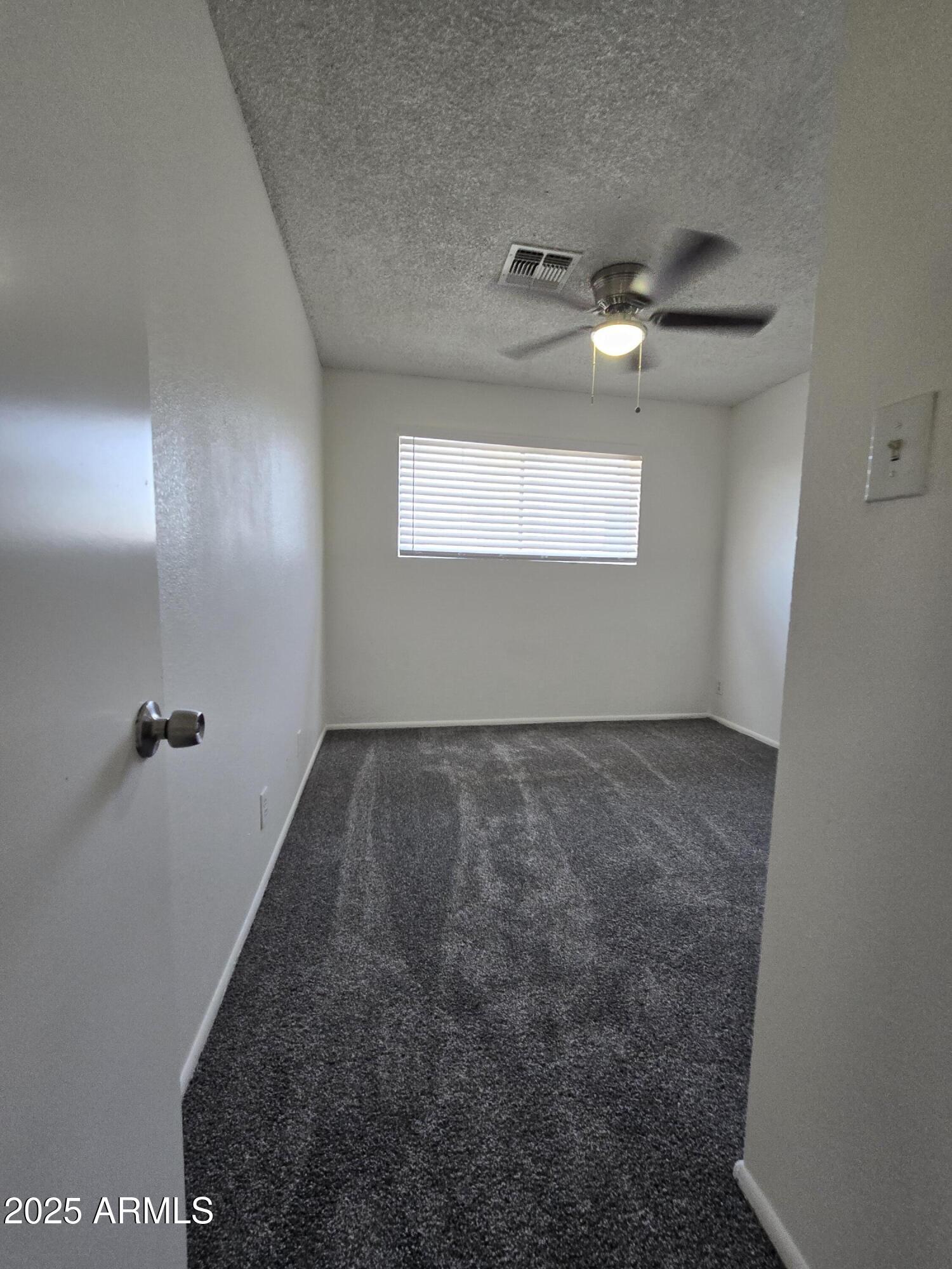 2211 West Pecan Road Phoenix, AZ 85041 - Photo 14 of 21 en empty room with windows and ceiling fan