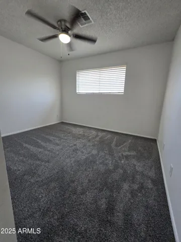 an empty room with a empty space and a ceiling fan