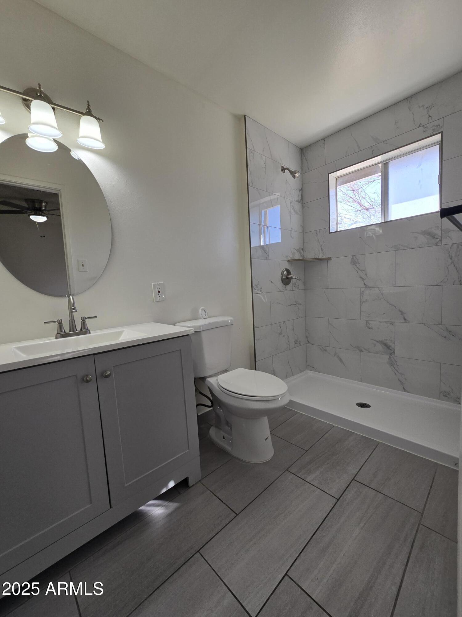 2211 West Pecan Road Phoenix, AZ 85041 - Photo 18 of 21 a bathroom with a toilet sink and shower