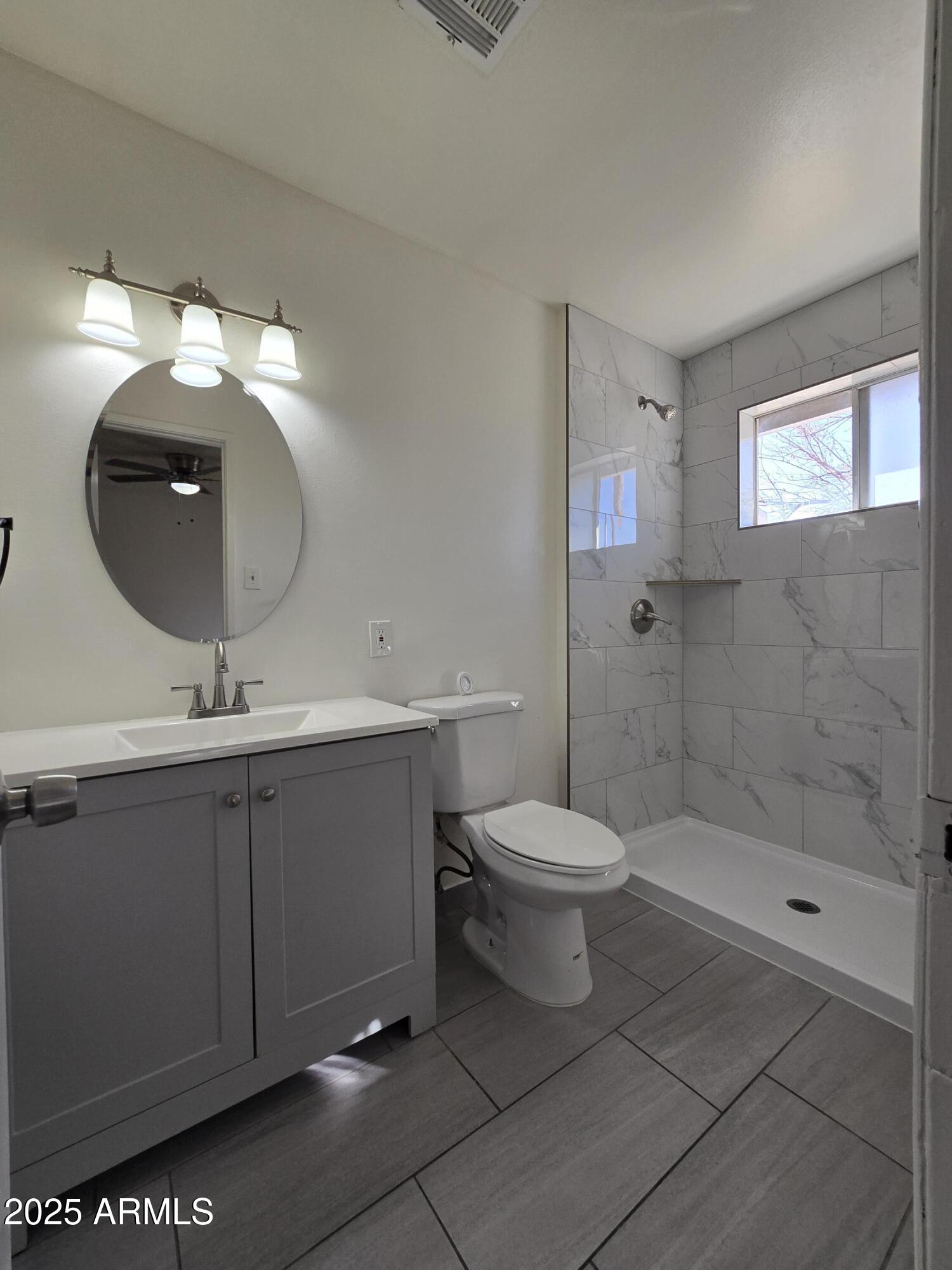 2211 West Pecan Road Phoenix, AZ 85041 - Photo 19 of 21 a bathroom with a toilet sink and shower