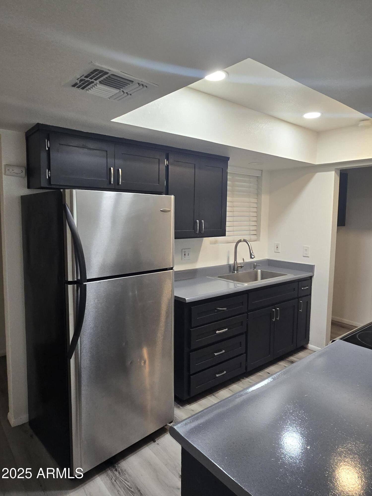 2211 West Pecan Road Phoenix, AZ 85041 - Photo 4 of 21 a kitchen with a refrigerator and a sink