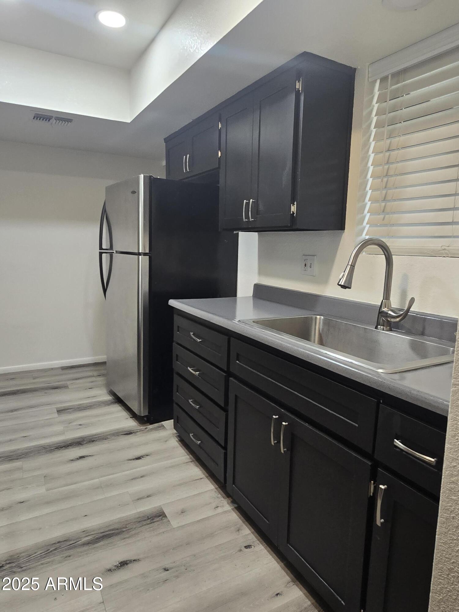 2211 West Pecan Road Phoenix, AZ 85041 - Photo 6 of 21 a kitchen with a sink and refrigerator