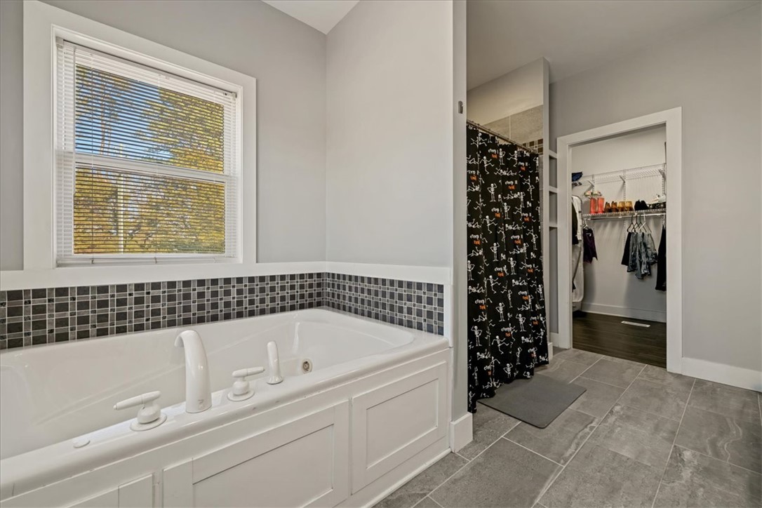 212 Winding Lane Seneca, SC 29672 - Photo 18 of 47 Relax in this inviting bathroom featuring a soaking tub and elegant tile flooring.