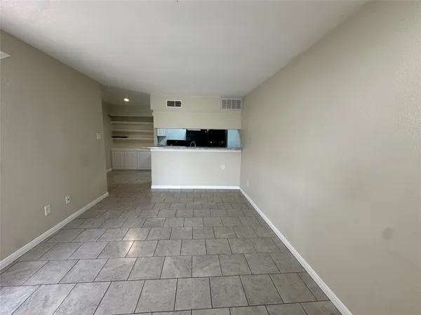 a kitchen with a refrigerator and cabinets