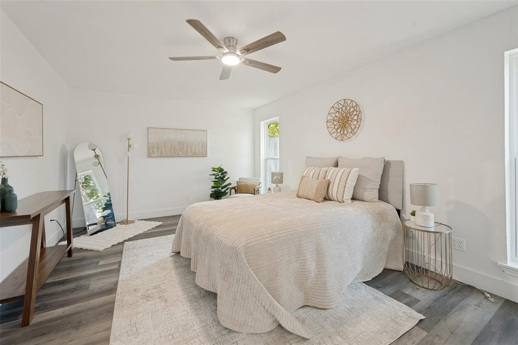3004 Raintree Court Bedford, TX 76021 - Photo 15 of 25 White walls, wood-finish flooring, ceiling fan with integrated lighting, and multiple windows