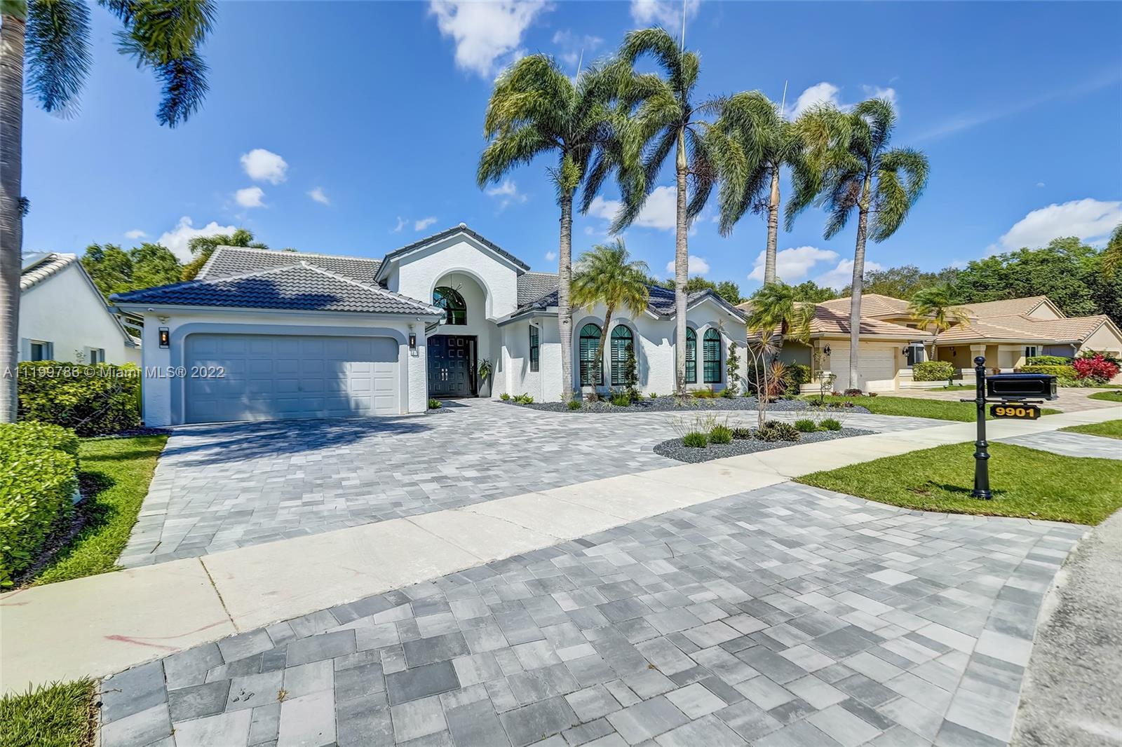 9901 North Abiaca Circle Davie, FL 33328 - Photo 1 of 46 a front view of a house with garden