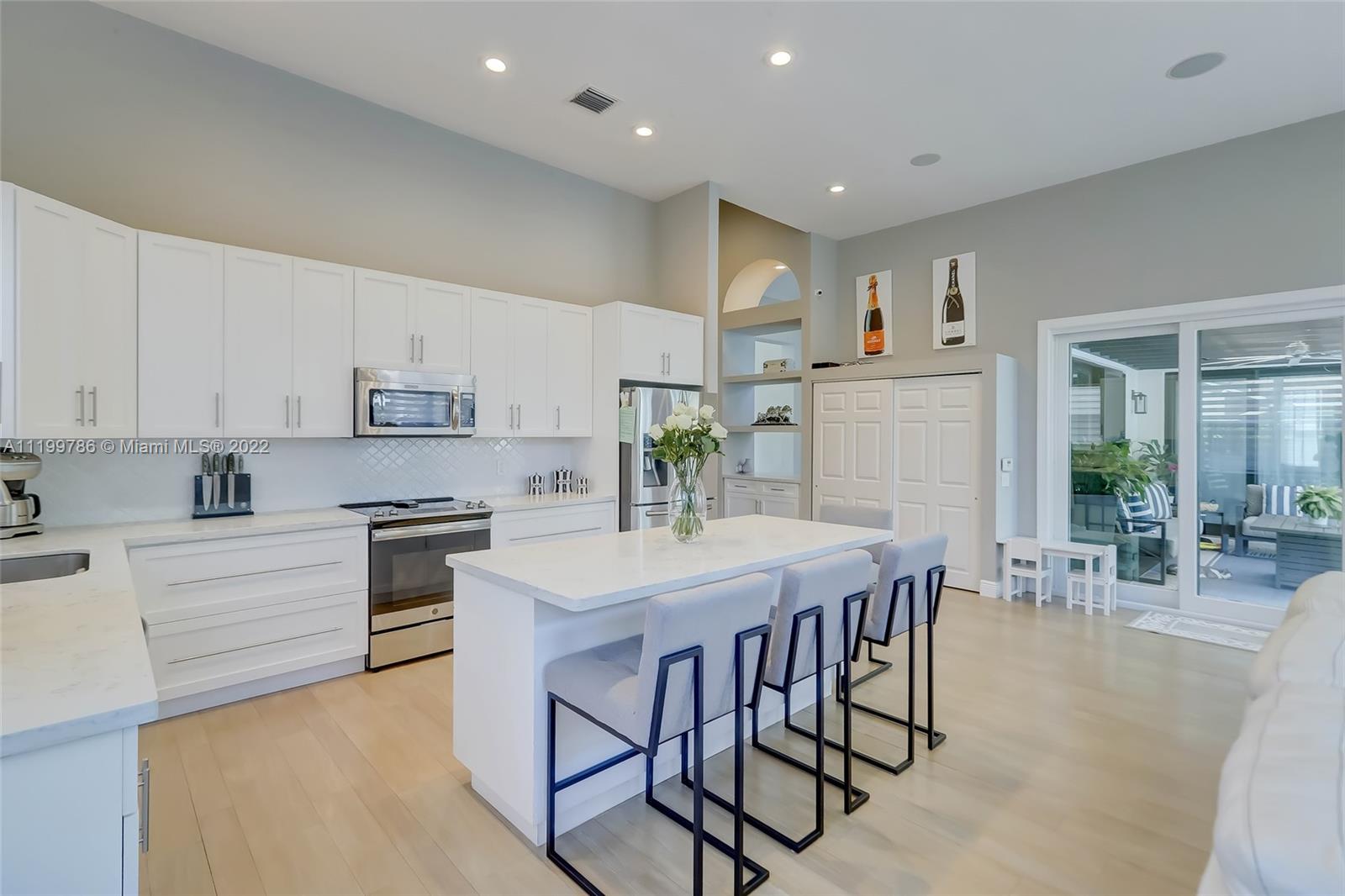 9901 North Abiaca Circle Davie, FL 33328 - Photo 11 of 46 a kitchen with stainless steel appliances a table and chairs in it
