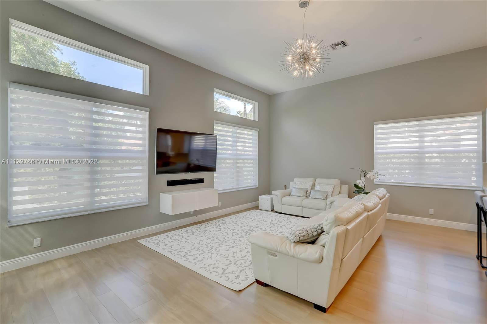 9901 North Abiaca Circle Davie, FL 33328 - Photo 16 of 46 a living room with furniture and a flat screen tv