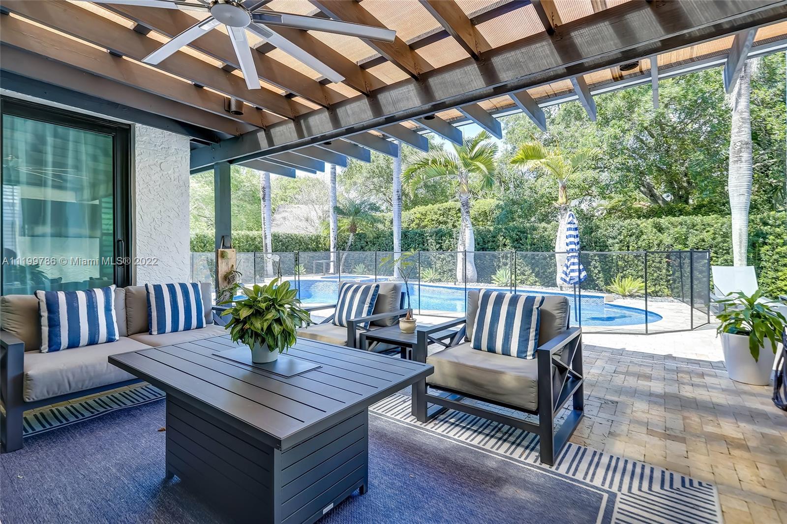 9901 North Abiaca Circle Davie, FL 33328 - Photo 20 of 46 a outdoor space with patio the couches and dining table with wooden floor