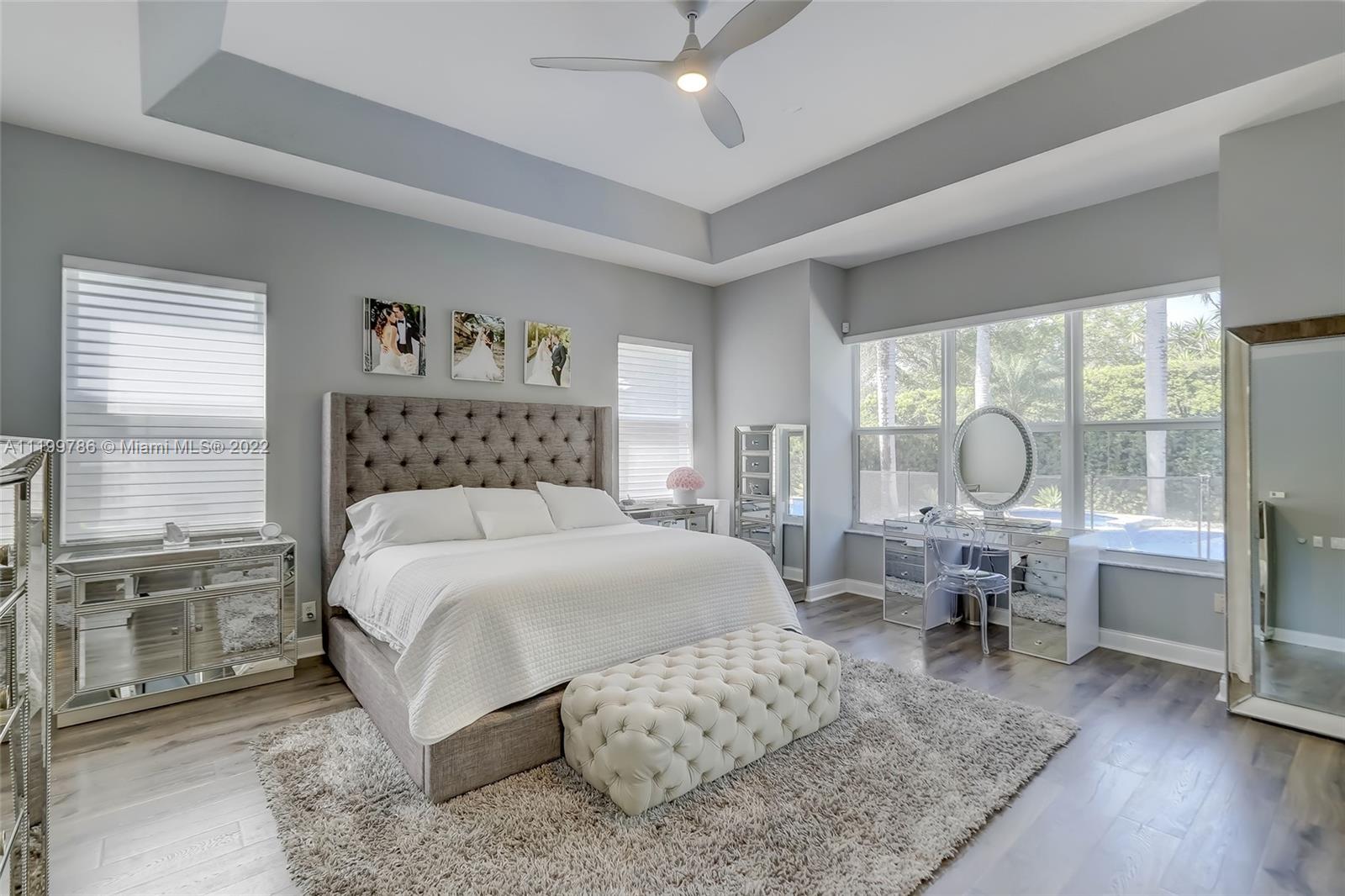 9901 North Abiaca Circle Davie, FL 33328 - Photo 27 of 46 a bedroom with a large bed and wooden floor