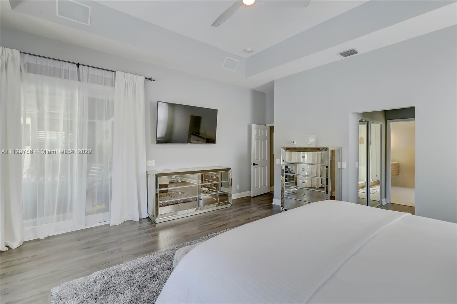 9901 North Abiaca Circle Davie, FL 33328 - Photo 28 of 46 a bedroom with a bed and a flat screen tv