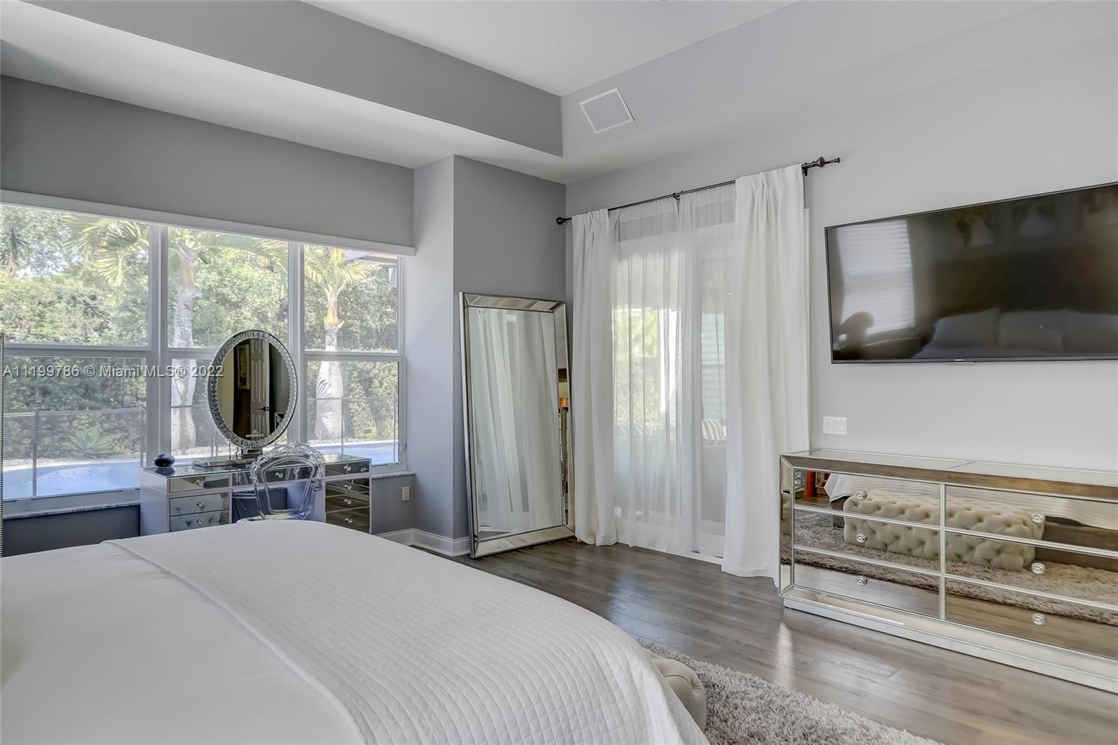 9901 North Abiaca Circle Davie, FL 33328 - Photo 29 of 46 a bedroom with a bed and a flat screen tv