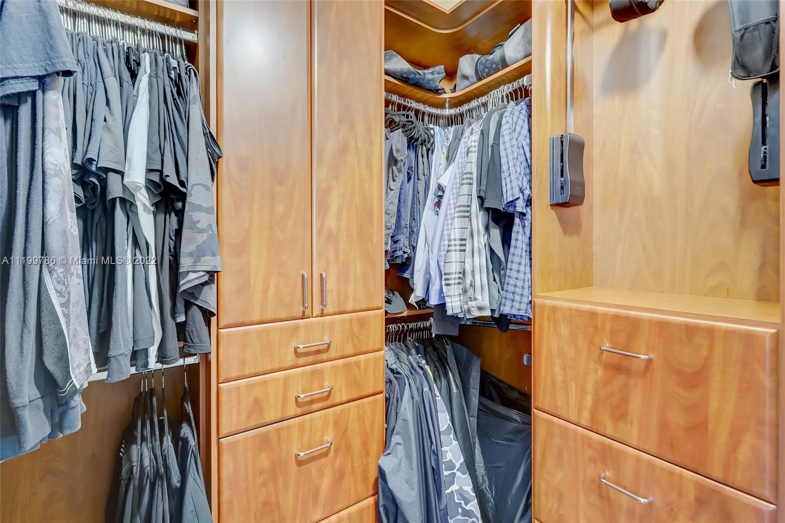 9901 North Abiaca Circle Davie, FL 33328 - Photo 35 of 46 a view of walk in closet with clothes and shoes