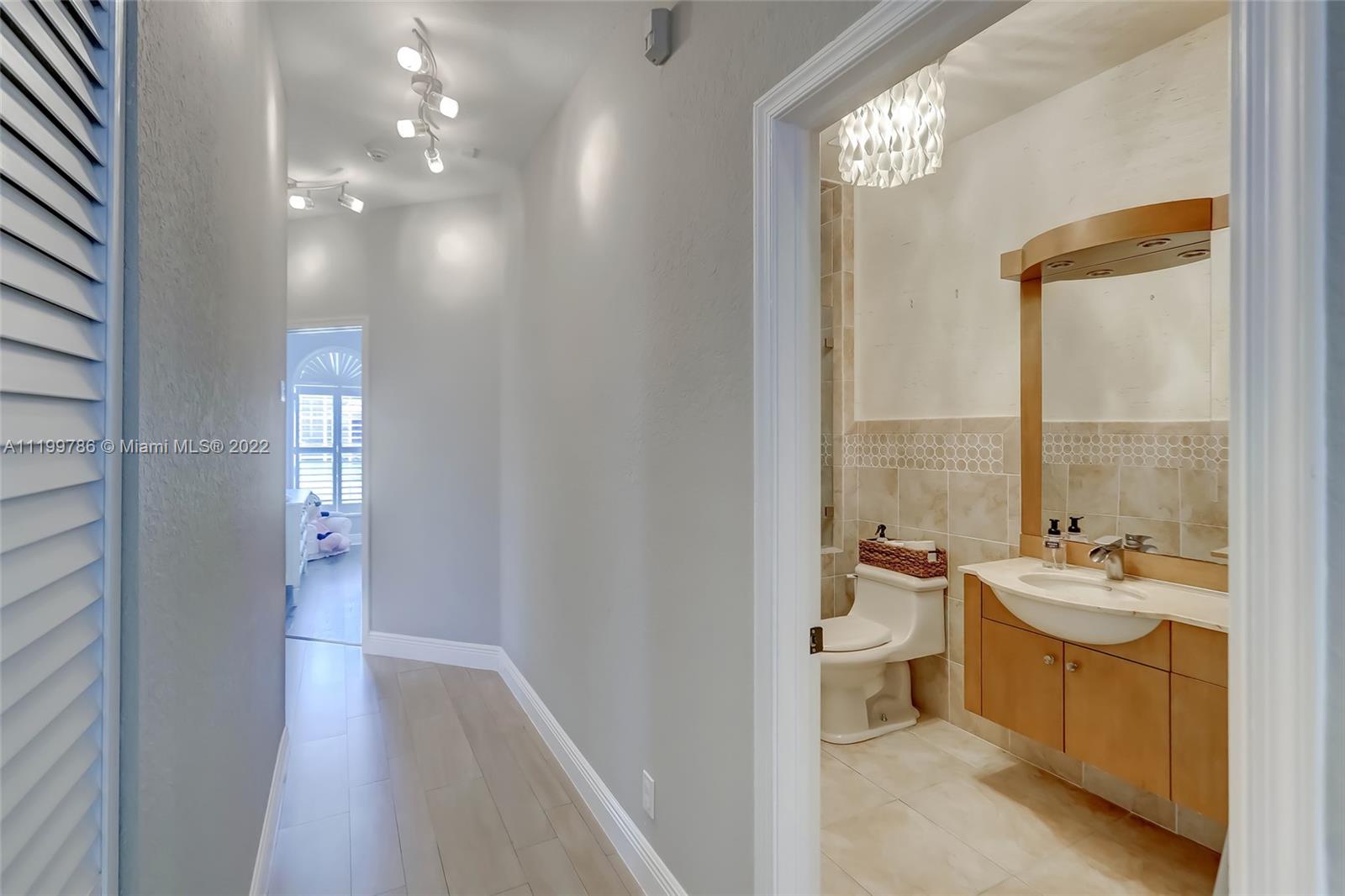 9901 North Abiaca Circle Davie, FL 33328 - Photo 36 of 46 a bathroom with a double vanity sink and a mirror
