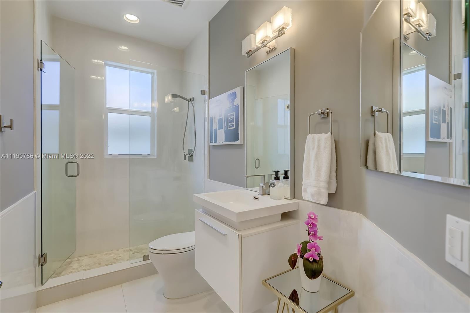9901 North Abiaca Circle Davie, FL 33328 - Photo 41 of 46 a bathroom with a sink mirror toilet and shower