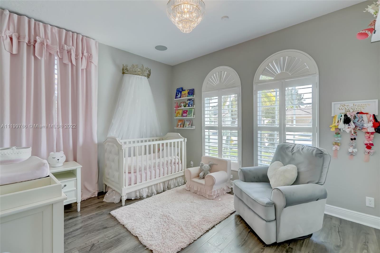 9901 North Abiaca Circle Davie, FL 33328 - Photo 42 of 46 a bedroom with furniture and a large window