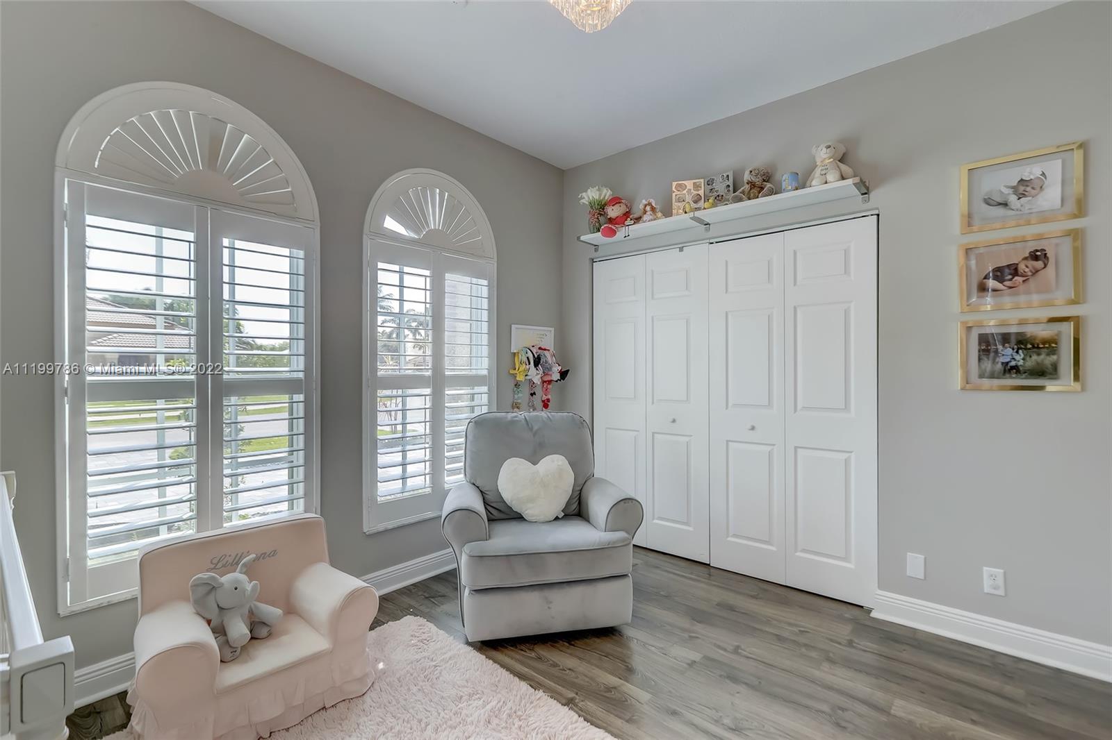 9901 North Abiaca Circle Davie, FL 33328 - Photo 43 of 46 a living room with furniture and a large window