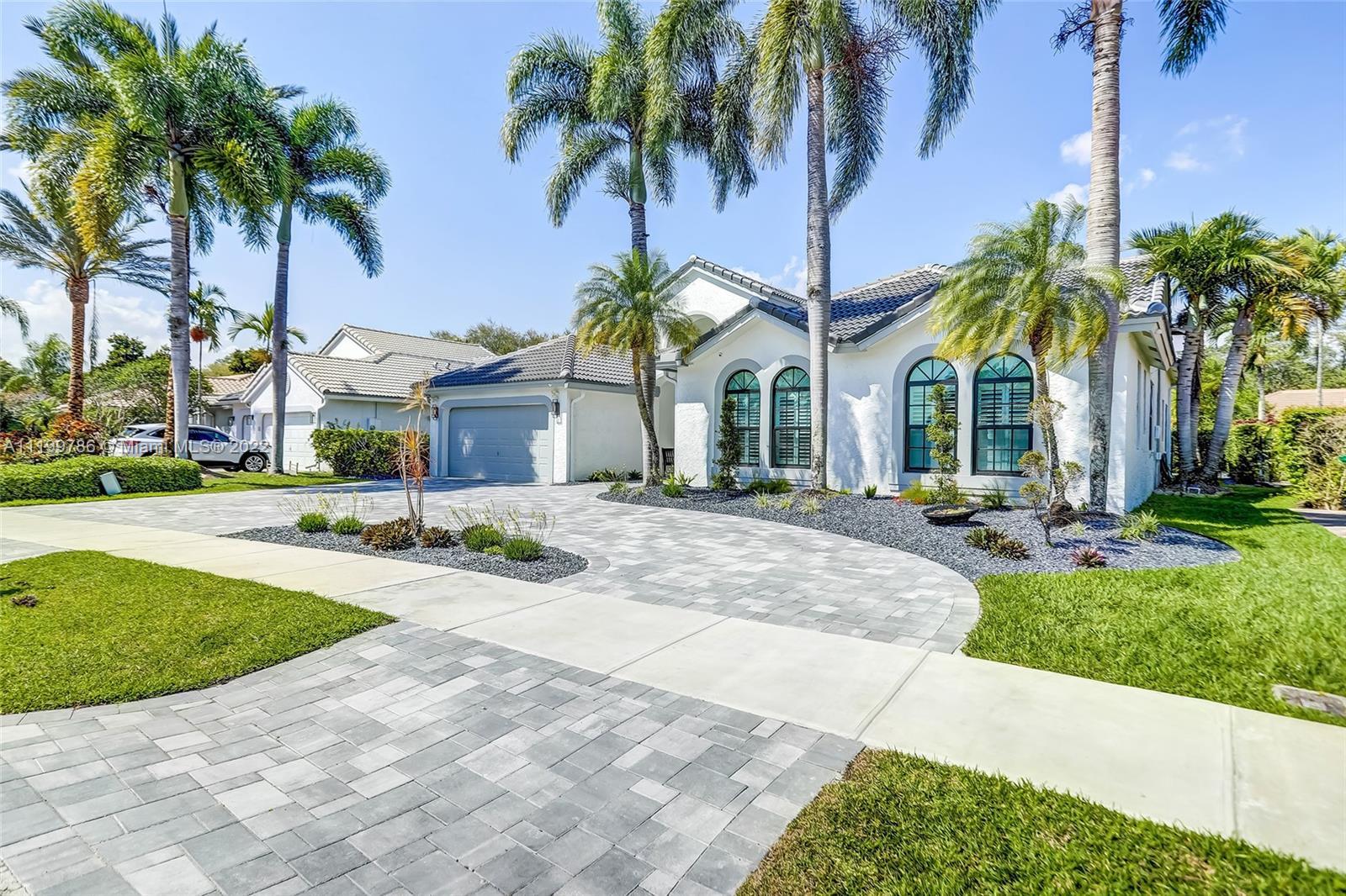 9901 North Abiaca Circle Davie, FL 33328 - Photo 46 of 46 a view of a white house with a swimming pool and a lawn chair