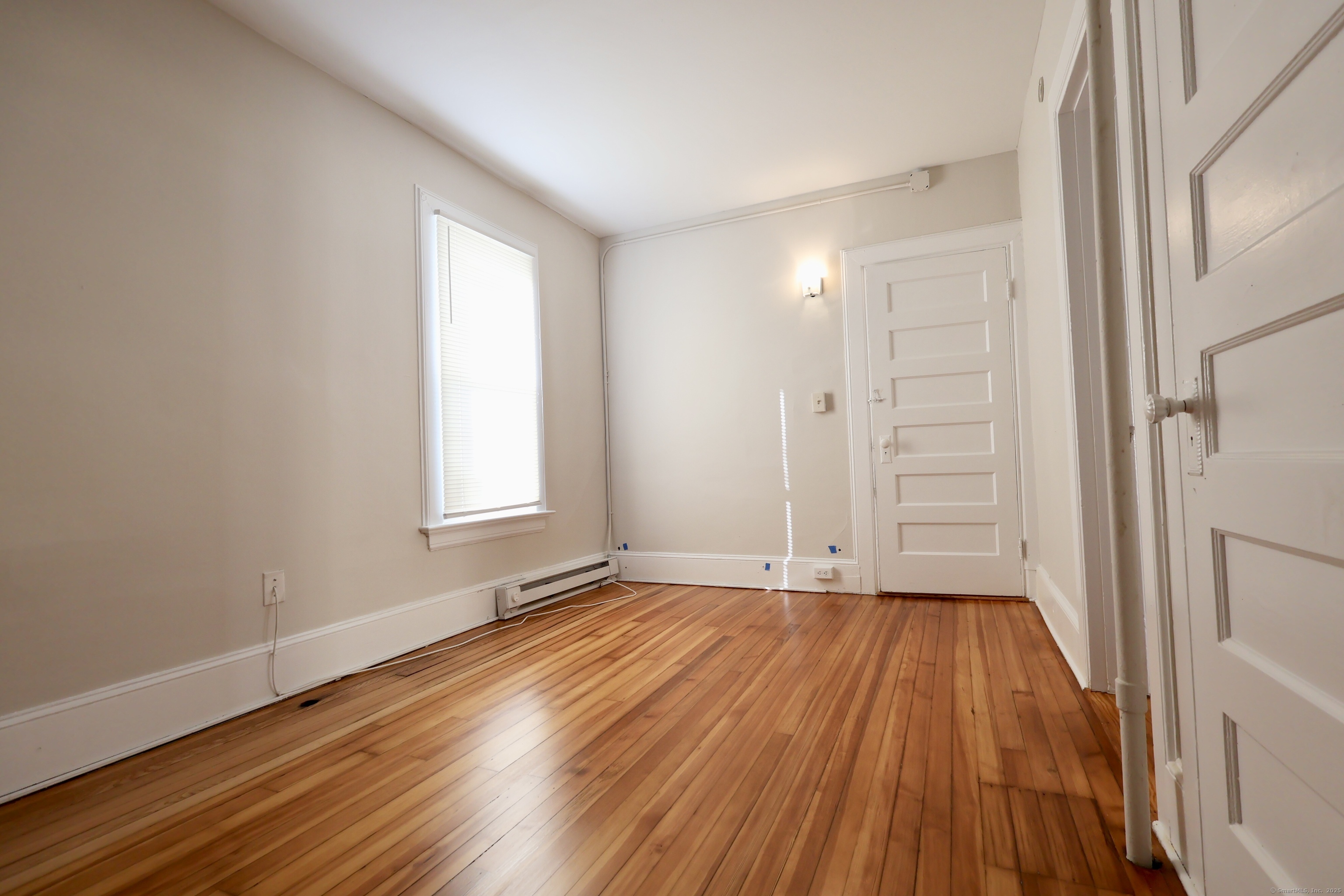 101 Stearns Street Bristol, CT 06010 - Photo 13 of 18 a view of an empty room with wooden floor and a window