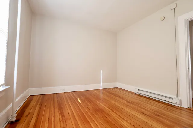 a view of a room with wooden floor