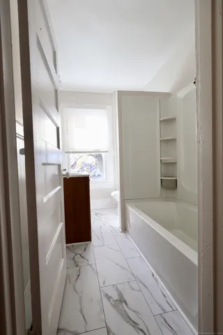 a bathroom with a bathtub and shower