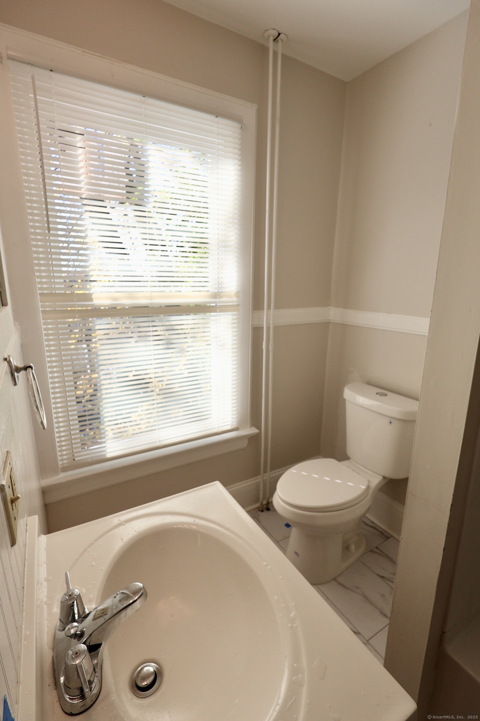 101 Stearns Street Bristol, CT 06010 - Photo 18 of 18 a bathroom with a sink and a toilet