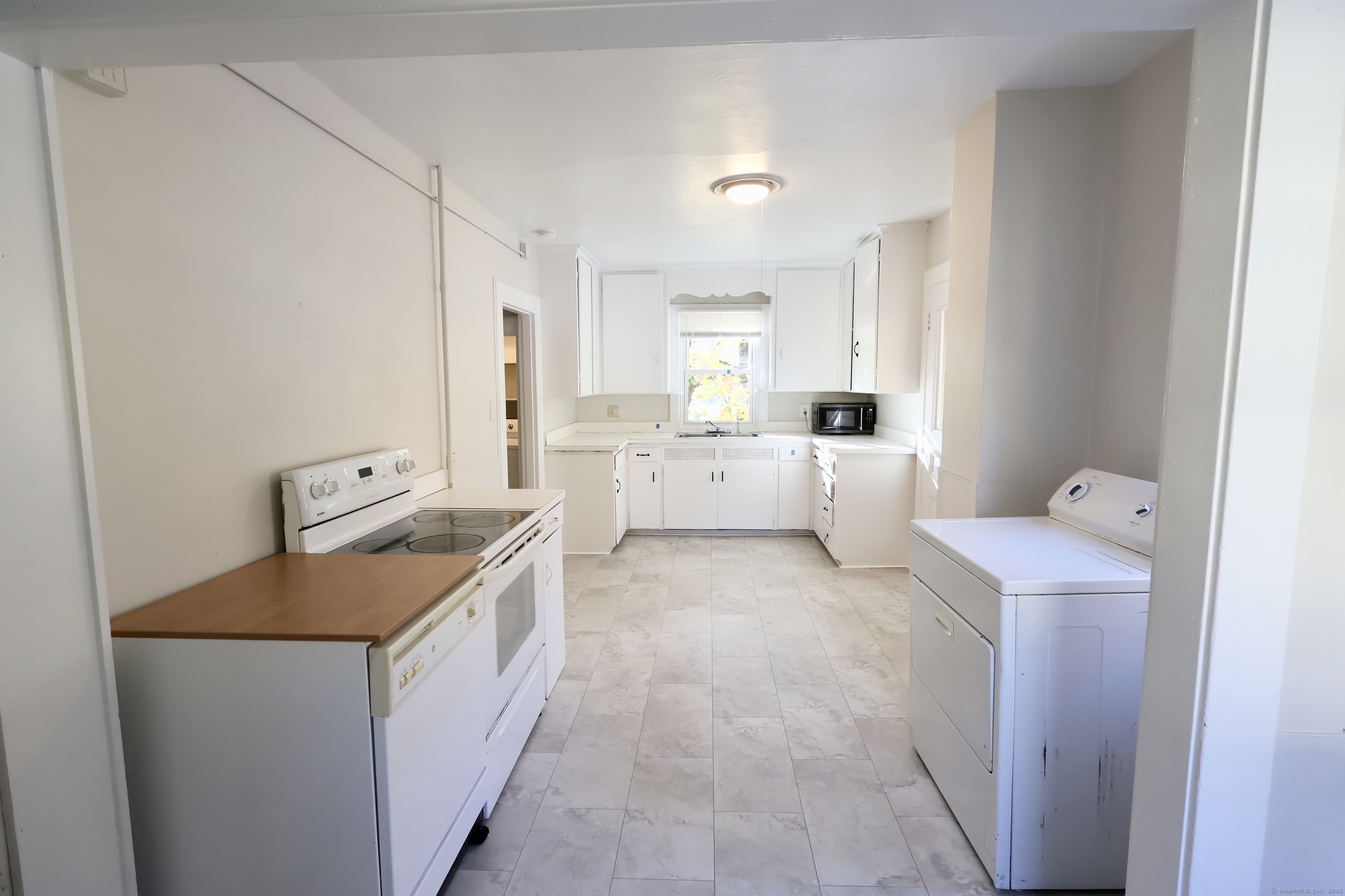 101 Stearns Street Bristol, CT 06010 - Photo 3 of 18 a utility room with cabinets washer and dryer
