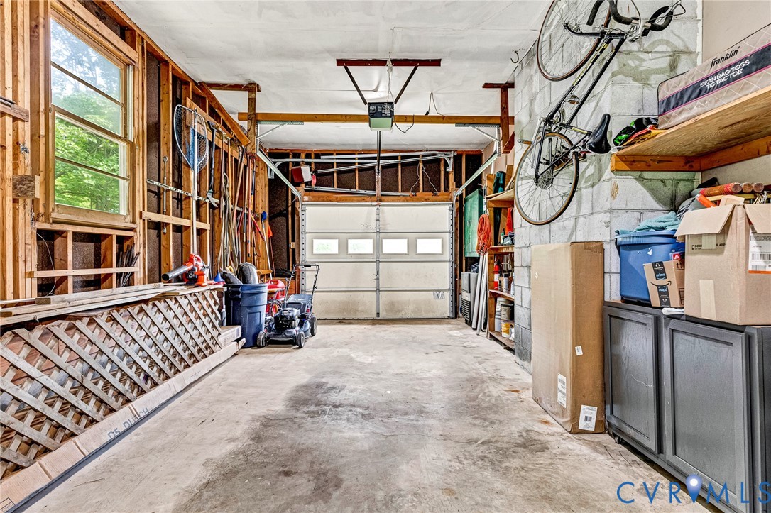 635 River Oaks Road Center Cross, VA 22437 - Photo 37 of 63 Concrete flooring garage featuring a paneled overh