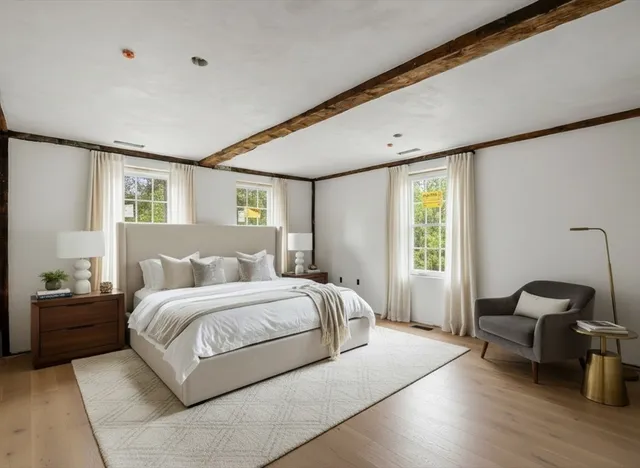 a bedroom with a bed and a chair