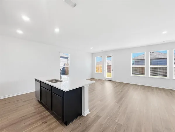 a kitchen with kitchen island a sink stainless steel appliances and cabinets