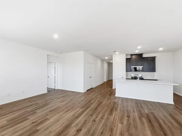 a view of an empty room and wooden floor