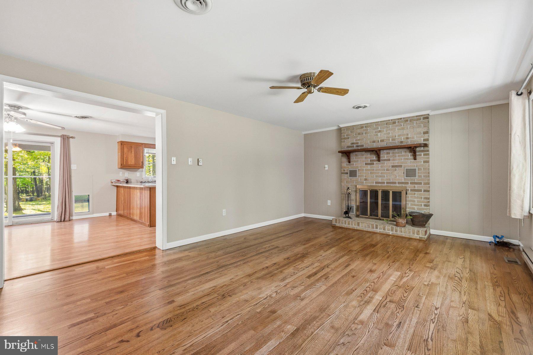 10820 Gambrill Park Road Frederick, MD 21702 - Photo 7 of 35 Living room with warm wood floors and fireplace!