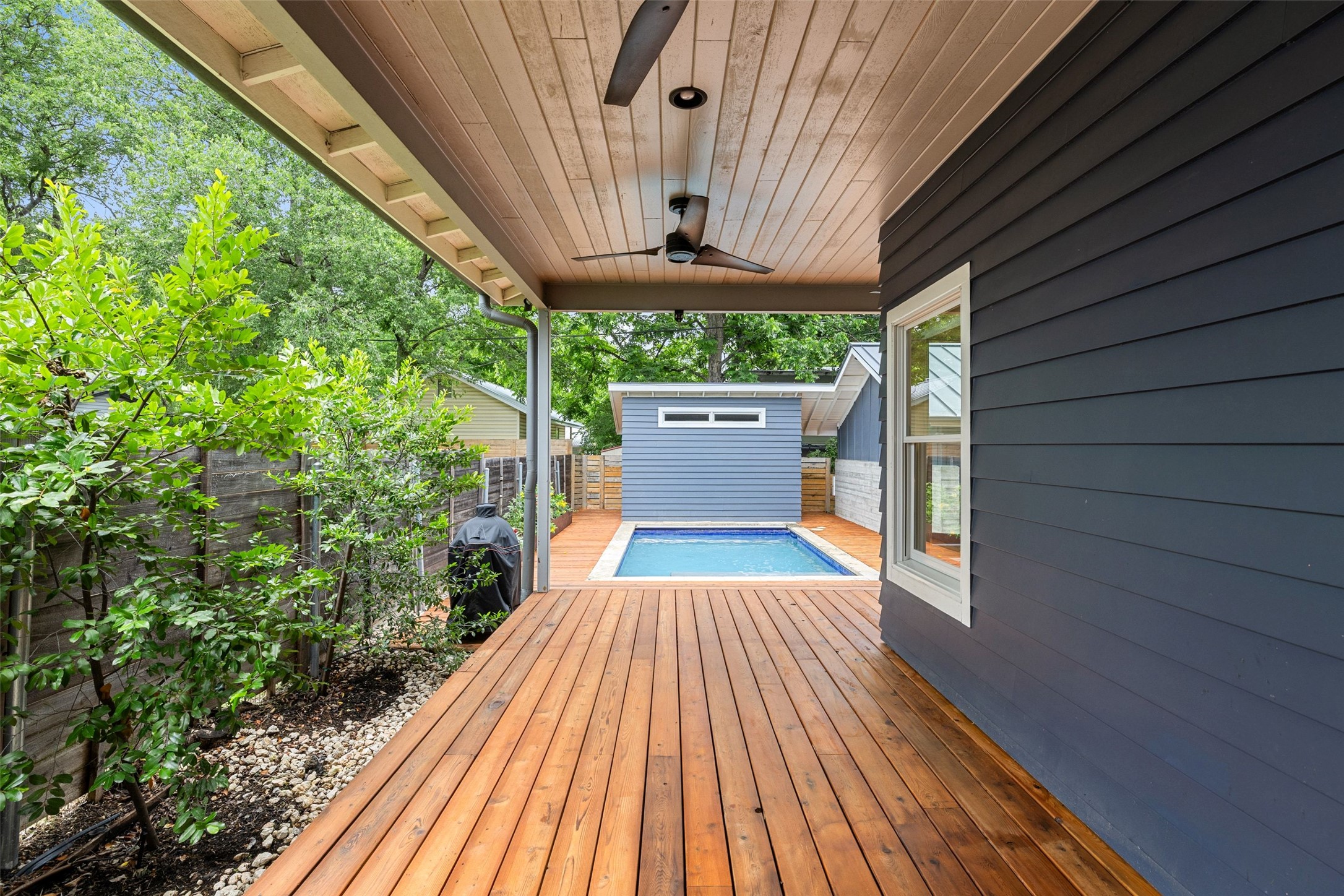 2000 Rundell Place Austin, TX 78704 - Photo 33 of 38 A spacious wooden deck provides ample outdoor living space, leading to a private pool and a charming detached shed.