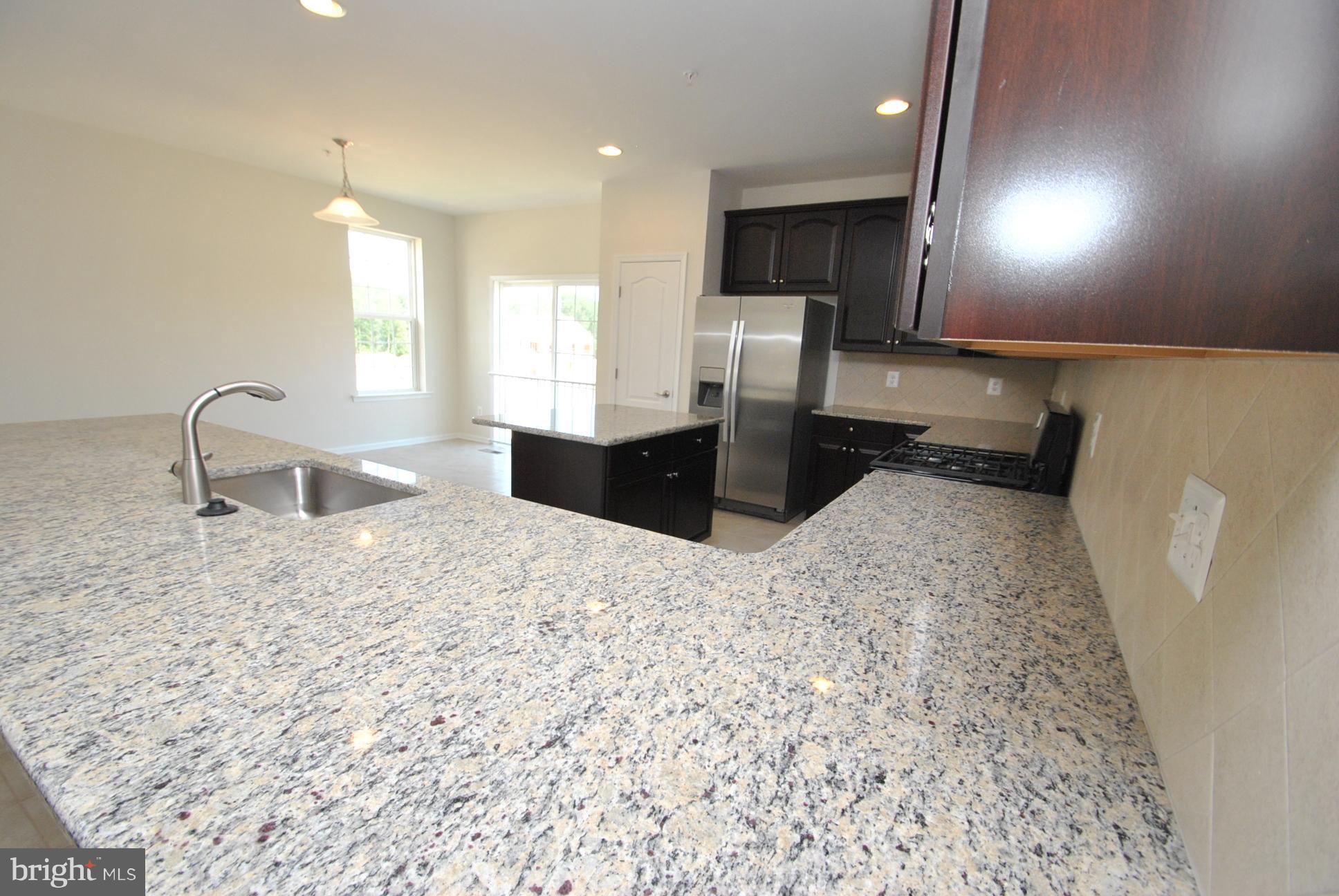 944 Winter Run Road Baltimore, MD 21220 - Photo 11 of 30 a kitchen with a refrigerator and a sink