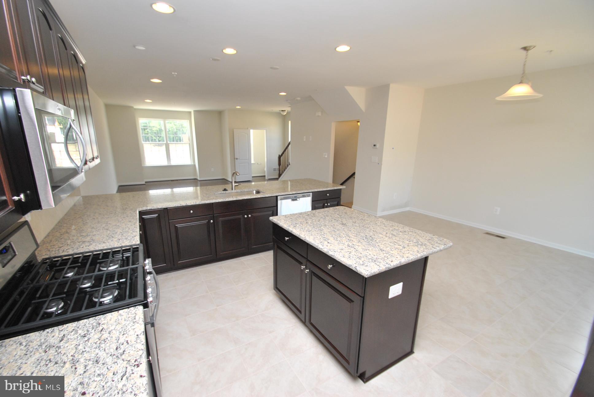 944 Winter Run Road Baltimore, MD 21220 - Photo 13 of 30 a kitchen with stainless steel appliances granite countertop a sink stove and cabinets