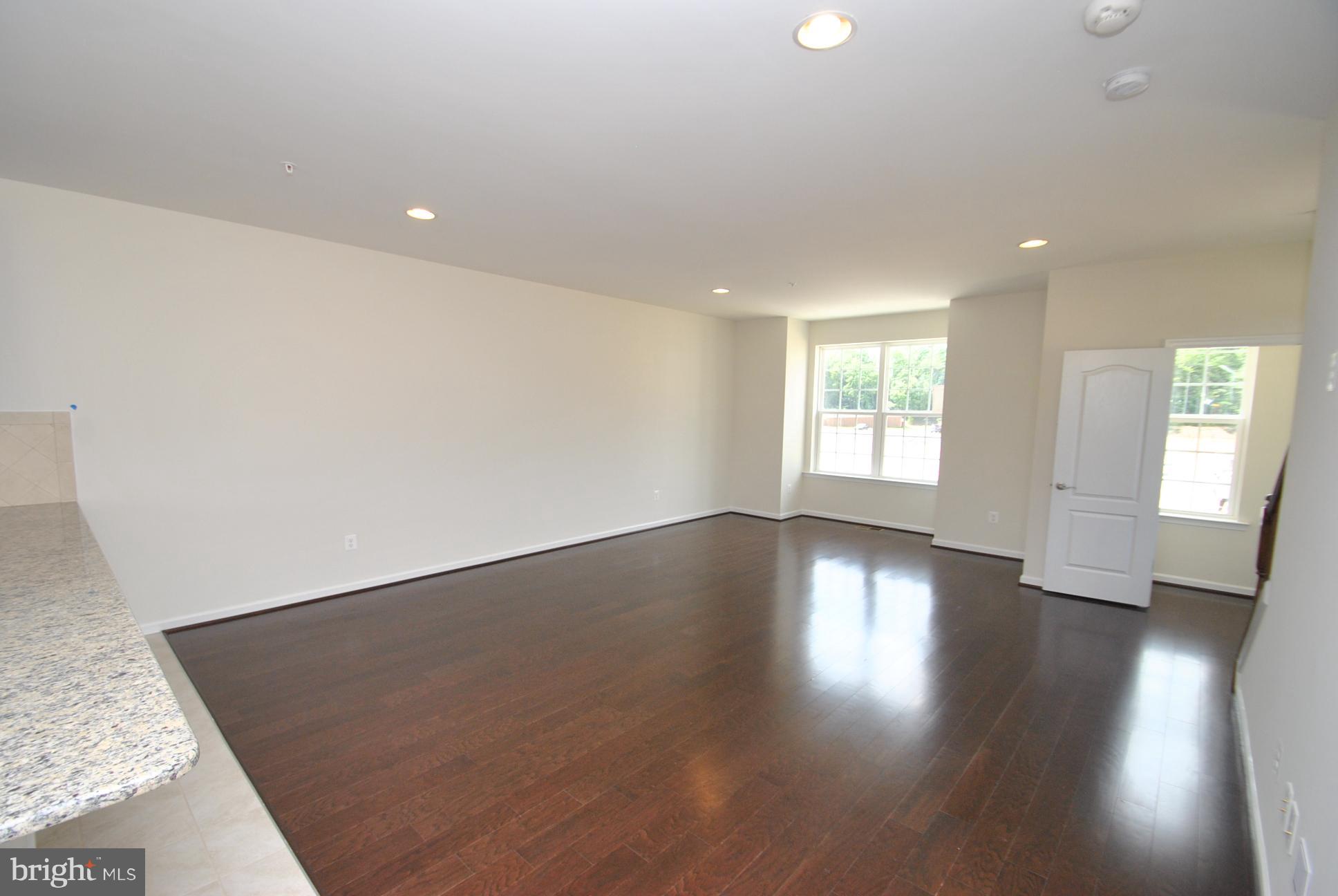 944 Winter Run Road Baltimore, MD 21220 - Photo 9 of 30 an empty room with wooden floor and windows