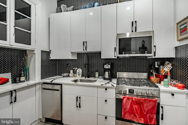 a kitchen with a sink stove and cabinets