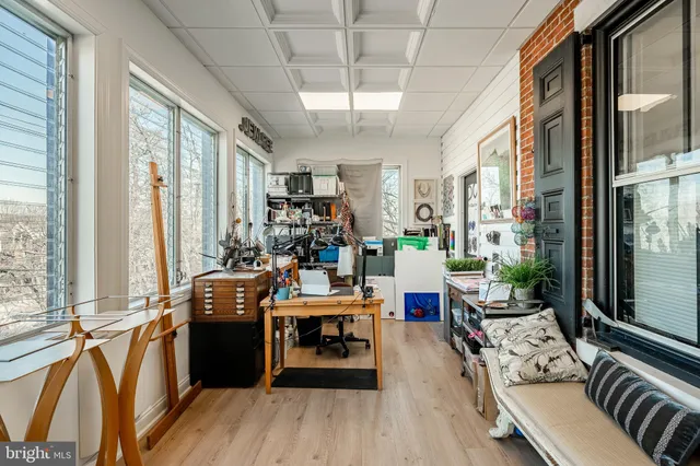 a view of a living room with furniture and floor to ceiling windows