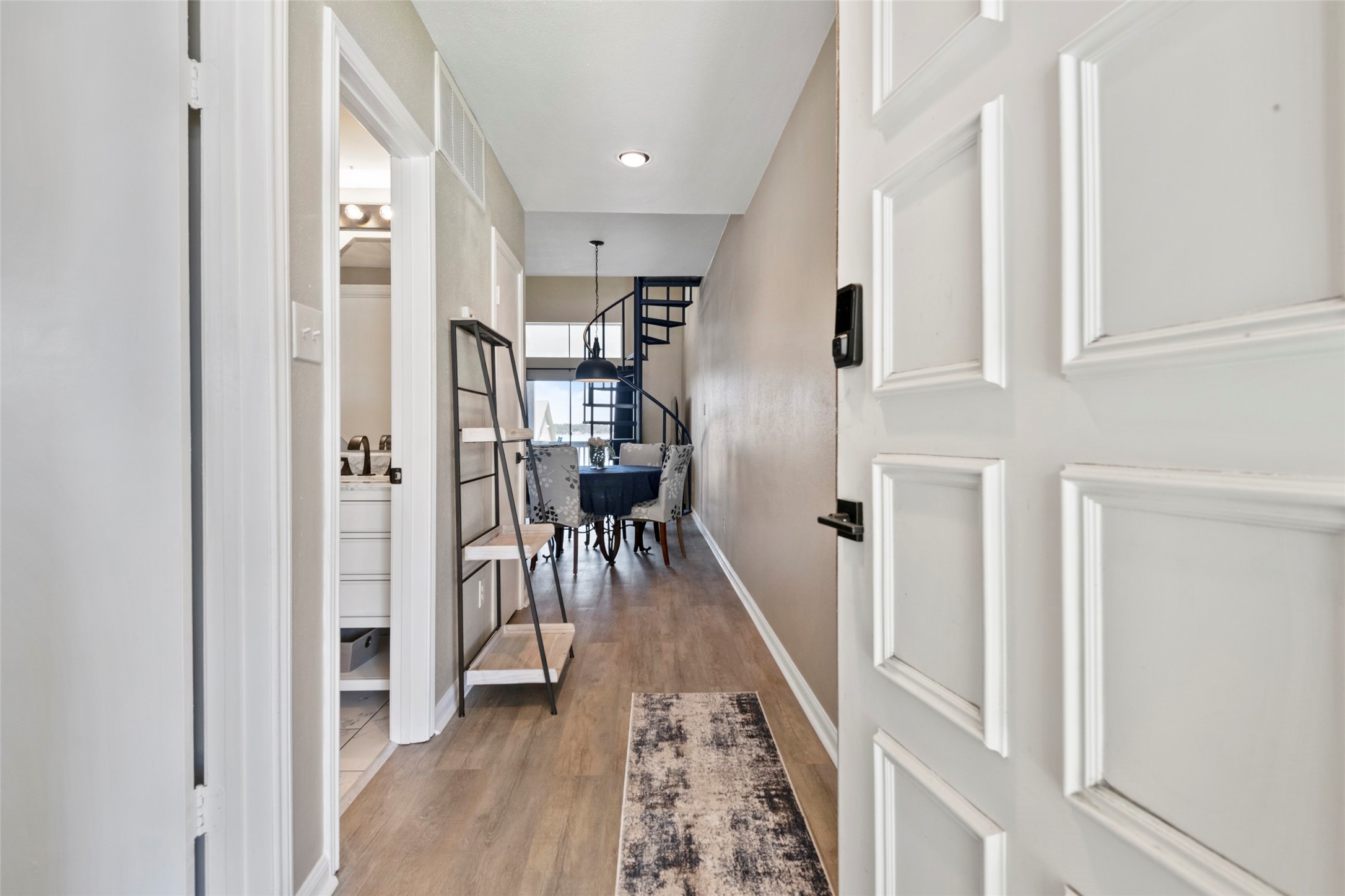 162 April Point Drive South Conroe, TX 77356 - Photo 4 of 26 a view of a hallway with wooden floor and livingroom with furniture