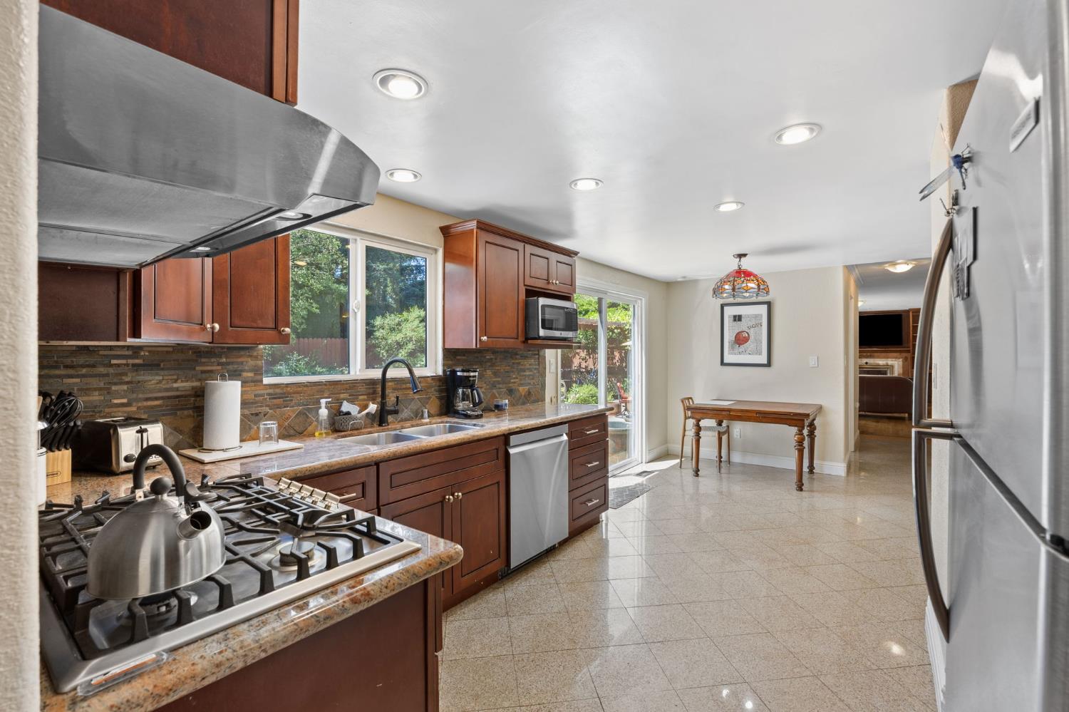 4206 Zephyr Way Sacramento, CA 95821 - Photo 12 of 45 a kitchen with stainless steel appliances granite countertop a sink stove and refrigerator