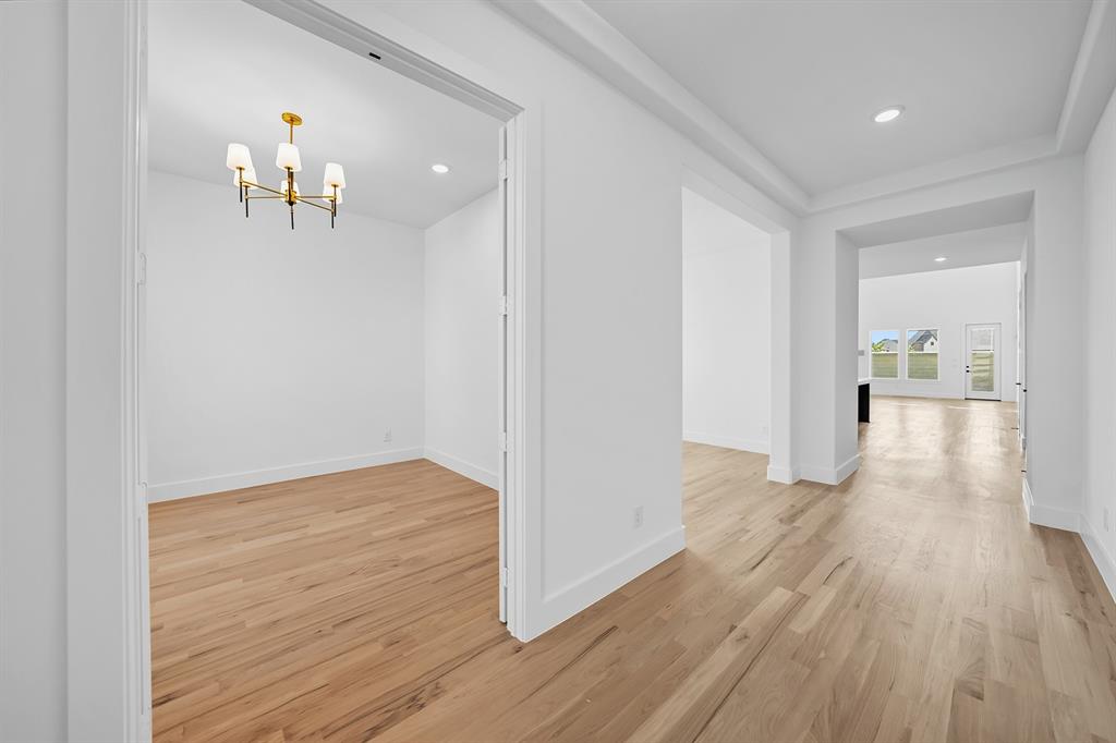 587 Mayfair Lane Frisco, TX 75033 - Photo 5 of 37 a view of empty room with wooden floor